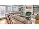 Comfortable living room featuring a fireplace, built-in shelving, and a large sectional sofa for relaxing and entertaining at 155 Woodcreek Ln, Fayetteville, GA 30215