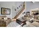 Spacious living room with staircase, comfortable seating, and accent rug at 155 Woodcreek Ln, Fayetteville, GA 30215