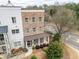Aerial view of beautiful townhome featuring brick elements, covered porch, and lush landscaping at 2026 Forte Ln, Alpharetta, GA 30009