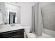 Bathroom with a dark wood cabinet, marble countertop and tiled shower provides a spa-like experience at 2026 Forte Ln, Alpharetta, GA 30009