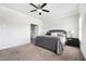 Well-lit primary bedroom with a ceiling fan and adjacent bathroom at 2026 Forte Ln, Alpharetta, GA 30009