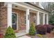 Charming brick home featuring a covered porch with white columns and landscaped front yard at 2026 Forte Ln, Alpharetta, GA 30009