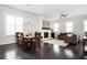 Open-concept living area, featuring a dining table and fireplace with a TV mounted above at 2026 Forte Ln, Alpharetta, GA 30009
