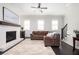 Inviting living room featuring a brick fireplace, dark hardwood floors and neutral color palette at 2026 Forte Ln, Alpharetta, GA 30009