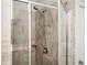 Newly tiled shower with glass doors and a built-in shelf at 2026 Forte Ln, Alpharetta, GA 30009
