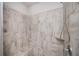 Updated shower showcasing elegant stone-look tile and a convenient bench at 2026 Forte Ln, Alpharetta, GA 30009