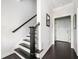 Entryway featuring a staircase with dark wood railing and hardwood floors at 2026 Forte Ln, Alpharetta, GA 30009