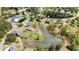 An aerial view showcasing a community that includes a tranquil lake and community tennis courts at 2503 Westchester Se Way, Conyers, GA 30013