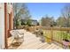 Relaxing wooden back deck with rocking chair and serene views of the landscaped backyard at 2503 Westchester Se Way, Conyers, GA 30013