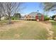Wide backyard space featuring a well-kept lawn, mature trees, and a view of the house at 2503 Westchester Se Way, Conyers, GA 30013