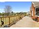 Expansive wooden deck overlooking a tranquil backyard and pond with lush greenery at 2503 Westchester Se Way, Conyers, GA 30013