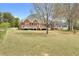 Large backyard with a view of the brick home and wooden deck, perfect for outdoor activities at 2503 Westchester Se Way, Conyers, GA 30013