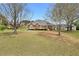 Expansive backyard featuring lush green lawn and mature trees, enhancing privacy and tranquility at 2503 Westchester Se Way, Conyers, GA 30013