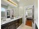 Bathroom vanity with double sinks and large mirror, connecting to bedroom through an open door at 2503 Westchester Se Way, Conyers, GA 30013