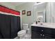 Bathroom with a black vanity, white sink, and a shower with black and red curtains at 2503 Westchester Se Way, Conyers, GA 30013