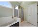 Bright bathroom featuring a tiled floor, soaking tub, and separate glass-enclosed shower stall at 2503 Westchester Se Way, Conyers, GA 30013