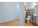 View of a half bathroom featuring hardwood floors, a pedestal sink, and a stylish, modern shelving unit at 2503 Westchester Se Way, Conyers, GA 30013