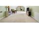 Spacious bonus room featuring neutral carpet, soft green walls, and an inviting armchair at 2503 Westchester Se Way, Conyers, GA 30013
