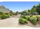 Well-manicured community entrance with decorative landscaping and secure gate at 2503 Westchester Se Way, Conyers, GA 30013