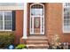 Elegant front door with decorative glass, flanked by sidelights and black shutters, inviting and secure at 2503 Westchester Se Way, Conyers, GA 30013
