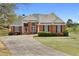 Inviting two-story brick home with manicured lawn and curved driveway at 2503 Westchester Se Way, Conyers, GA 30013