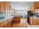 Open kitchen showcasing wood cabinets, breakfast bar, and plenty of natural light at 2503 Westchester Se Way, Conyers, GA 30013