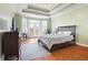 Inviting main bedroom with tray ceiling, balcony access, and neutral decor at 2503 Westchester Se Way, Conyers, GA 30013