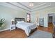 Cozy main bedroom with tray ceiling, natural light, and wood flooring at 2503 Westchester Se Way, Conyers, GA 30013