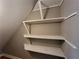 View of finished attic with open shelving and carpeting at 3512 Ten Oaks Ct, Powder Springs, GA 30127