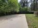 Open backyard area featuring a concrete pad and a built-in fire pit, enclosed by a wooden fence at 3512 Ten Oaks Ct, Powder Springs, GA 30127