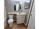 Bathroom features a toilet, sink, vanity and large mirror at 3512 Ten Oaks Ct, Powder Springs, GA 30127