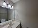 Well-lit bathroom featuring a large mirror, vanity, and neutral-toned walls at 3512 Ten Oaks Ct, Powder Springs, GA 30127