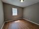 Neutral bedroom with hardwood floors and a large window at 3512 Ten Oaks Ct, Powder Springs, GA 30127
