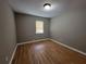 Bedroom featuring hardwood floors and a large window at 3512 Ten Oaks Ct, Powder Springs, GA 30127