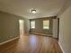 Spacious bedroom featuring gleaming hardwood floors, two large windows, and neutral paint at 3512 Ten Oaks Ct, Powder Springs, GA 30127