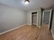 Neutral bedroom with hardwood floors, a closet, and entry to another room at 3512 Ten Oaks Ct, Powder Springs, GA 30127