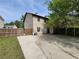 Two-story home exterior with a fenced backyard, concrete patio, and mature trees at 3512 Ten Oaks Ct, Powder Springs, GA 30127