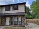 Two-story townhome with stone facade, neutral siding, and well-maintained landscaping at 3512 Ten Oaks Ct, Powder Springs, GA 30127