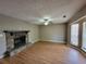 Spacious living room with stone fireplace, ceiling fan, and lots of natural light at 3512 Ten Oaks Ct, Powder Springs, GA 30127