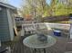 Back deck with outdoor table overlooking fenced yard surrounded by mature trees at 3657 Willow Wood Way, Lawrenceville, GA 30044