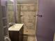 Tiled bathroom featuring a single sink vanity, standing shower and updated fixtures at 3657 Willow Wood Way, Lawrenceville, GA 30044