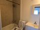 Bathroom with bathtub, tiled shower, single sink vanity, and neutral color palette at 3657 Willow Wood Way, Lawrenceville, GA 30044
