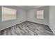 Cozy bedroom with two windows and modern gray laminate flooring providing a calm atmosphere at 4193 Port Chester Way, Decatur, GA 30034