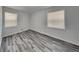 Bright bedroom with two windows and neutral walls showcasing attractive gray laminate flooring at 4193 Port Chester Way, Decatur, GA 30034