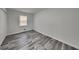 Bedroom featuring durable gray laminate flooring, neutral paint, and a convenient closet at 4193 Port Chester Way, Decatur, GA 30034
