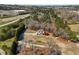 A stunning aerial view of a property with a sprawling lawn, a red barn, and a charming two-story home at 1130 Martins Chapel Rd, Lawrenceville, GA 30045