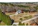 Expansive aerial view of a landscaped property featuring a well-manicured lawn and a charming two-story home at 1130 Martins Chapel Rd, Lawrenceville, GA 30045