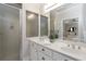 Bathroom with double sink vanity, large mirror, and glass enclosed shower at 1130 Martins Chapel Rd, Lawrenceville, GA 30045