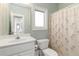 Bathroom with white vanity, toilet, and shower with patterned curtain at 1130 Martins Chapel Rd, Lawrenceville, GA 30045