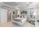 Bright bedroom adjacent to ensuite bathroom features tray ceiling, neutral tones, and ample natural light at 1130 Martins Chapel Rd, Lawrenceville, GA 30045